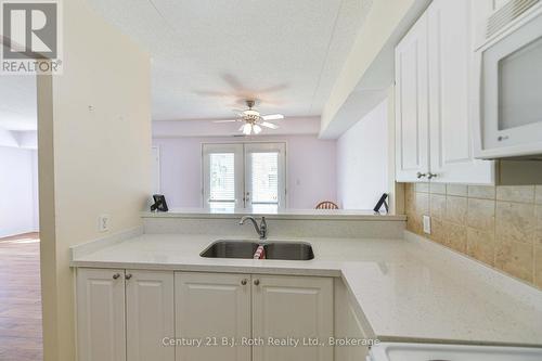 Double Sink - Unit 201 - 115 Bond Street, Orillia, ON - Indoor Photo Showing Kitchen With Double Sink