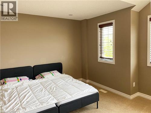 Carpeted room with recessed lighting and neutral-toned walls - 180 Huck Crescent, Kitchener, ON - Indoor Photo Showing Bedroom