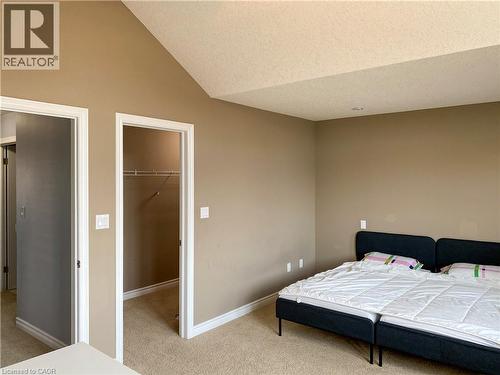 Room featuring neutral tone walls, white trim, and beige carpet flooring - 180 Huck Crescent, Kitchener, ON - Indoor Photo Showing Bedroom