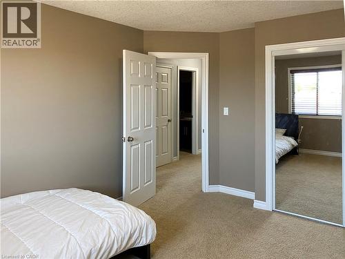 Carpeted room with neutral-toned walls, white trim, and a textured ceiling - 180 Huck Crescent, Kitchener, ON - Indoor Photo Showing Bedroom