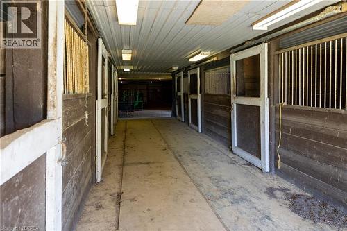 Barn interior featuring multiple stalls with wood construction and white trim - 269 Brant County Road 22, Ancaster, ON -  With Exterior