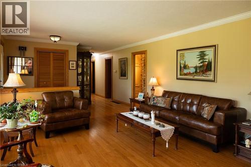 Spacious living area featuring wood-finish flooring, light-colored walls, and detailed crown molding - 269 Brant County Road 22, Ancaster, ON - Indoor Photo Showing Living Room