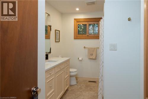 Bathroom featuring a cream-colored vanity with a light-toned countertop, a rectangular undermount sink, and a framed mirror - 269 Brant County Road 22, Ancaster, ON - Indoor Photo Showing Bathroom