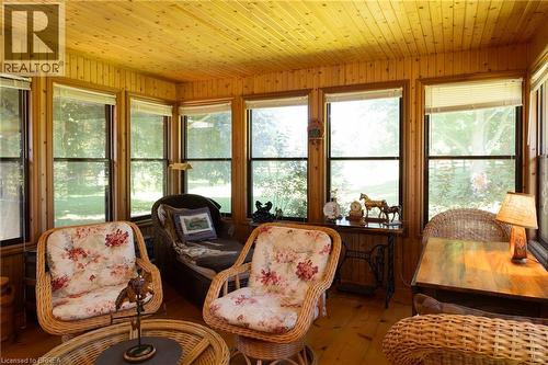 Sunroom featuring extensive natural wood plank walls and ceilings, numerous windows, and wood-finish flooring - 269 Brant County Road 22, Ancaster, ON - Indoor