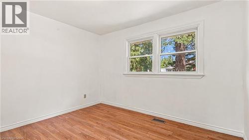 Room with wood-finish flooring, white walls, and white baseboards - 524 Dorval Drive, Ancaster, ON - Indoor Photo Showing Other Room