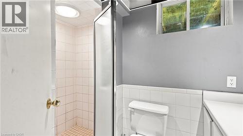 Shower stall with tiled walls and floor, enclosed by a glass and metal frame - 524 Dorval Drive, Ancaster, ON - Indoor Photo Showing Bathroom