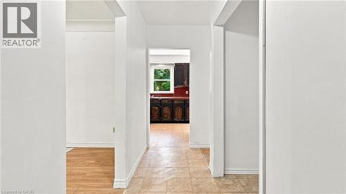 Hallway with neutral wall tones and diverse flooring, including light-toned wood-finish flooring and patterned floor tiles - 524 Dorval Drive, Ancaster, ON - Indoor Photo Showing Other Room