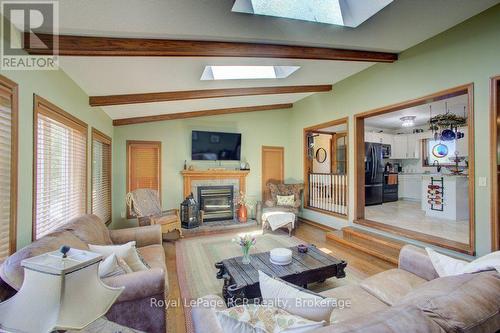 Sunken living room with wood stove - 7195 Sixteenth Line, Mapleton, ON 