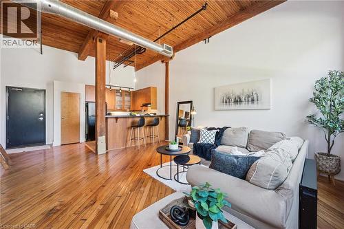 Open-concept living area with high vaulted ceilings and exposed wood beams - 26 Ontario Street Unit# 127, Guelph, ON - Indoor Photo Showing Living Room