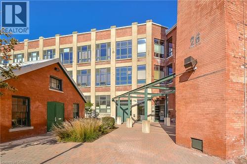 Brick exterior structure featuring large multi-pane windows and a covered entryway - 26 Ontario Street Unit# 127, Guelph, ON - Outdoor With Exterior