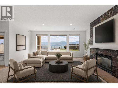 Lower Living - virtually staged - 1581 Gregory Road, West Kelowna, BC - Indoor Photo Showing Living Room With Fireplace