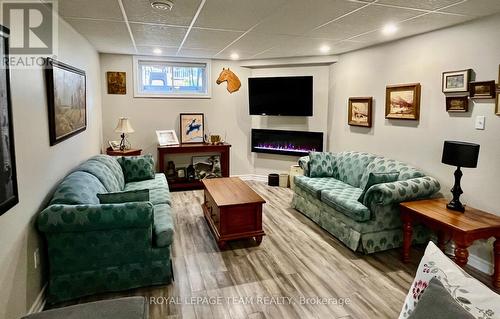 Family room with electric fireplace - 14 Otteridge Avenue, Renfrew, ON - Indoor Photo Showing Basement