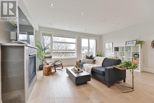 Family room with w/o to deck + cozy gas fireplace - 69 Holmstead Avenue, Toronto, ON - Indoor Photo Showing Living Room