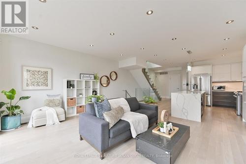 Family room with w/o to deck + cozy gas fireplace - 69 Holmstead Avenue, Toronto, ON - Indoor Photo Showing Living Room