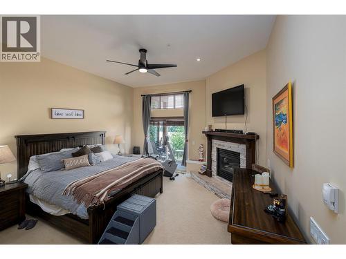 5045 Snowbird Way Unit# 2, Big White, BC - Indoor Photo Showing Bedroom With Fireplace