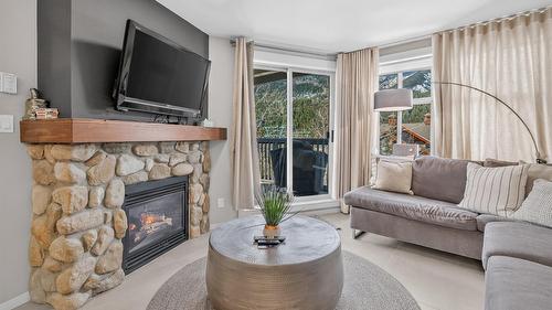 202-2050 Summit Drive, Panorama, BC - Indoor Photo Showing Living Room With Fireplace
