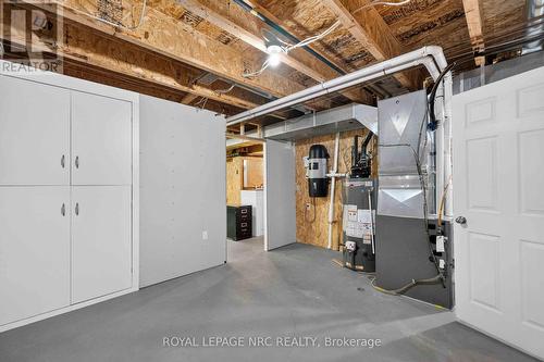 Utility Room with Owned Hot Water Tank - 82 Maple Street, Port Colborne (Sugarloaf), ON - Indoor Photo Showing Basement