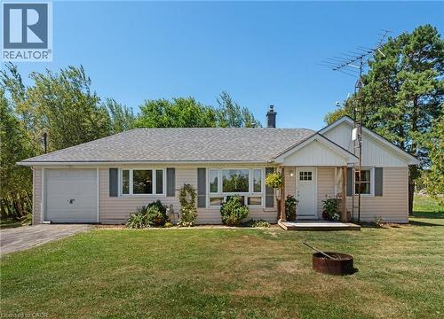 Ranch-style residence featuring light-colored siding, a gray shingle roof, and an attached single-car garage - 3 Bousfield Lane, Jarvis, ON - Outdoor With Facade
