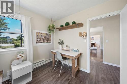 Space featuring wood-finish flooring, a window offering exterior views, and a doorway opening to an additional room - 3 Bousfield Lane, Jarvis, ON - Indoor