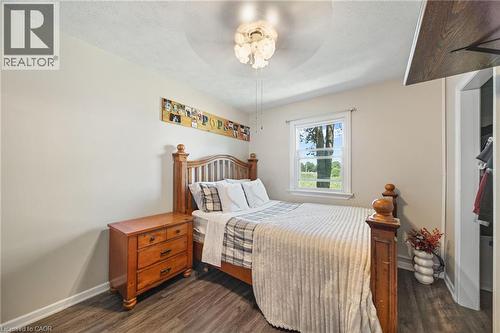 Bedroom featuring wood-finish flooring, a window with exterior views, and a ceiling fan with integrated lighting - 3 Bousfield Lane, Jarvis, ON - Indoor Photo Showing Bedroom