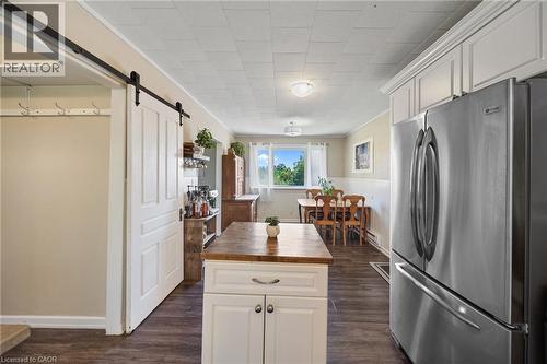 Kitchen featuring wood-finish flooring, white cabinetry with crown molding, and a stainless steel refrigerator - 3 Bousfield Lane, Jarvis, ON - Indoor Photo Showing Kitchen