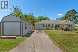 Exterior featuring light-colored siding, a covered front entry, and a prominent front-facing window array - 