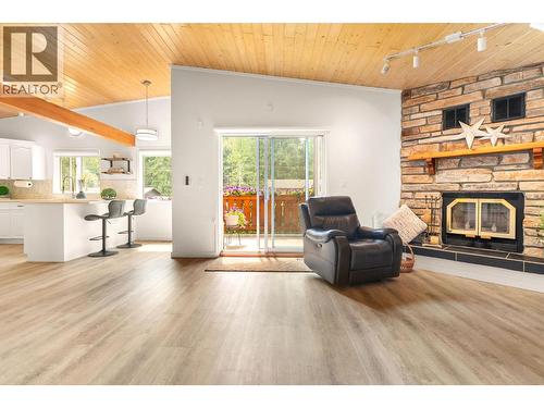 Open concept main floor - 1587 Pratico Road, Revelstoke, BC - Indoor Photo Showing Living Room With Fireplace