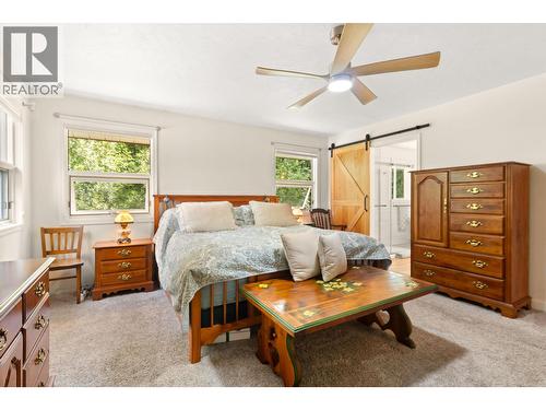 Primary bedroom main floor has large closest and attached full ensuite - 1587 Pratico Road, Revelstoke, BC - Indoor Photo Showing Bedroom