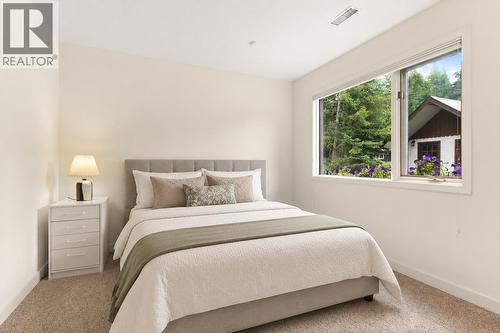 Bedroom 2 lower level this picture digitally staged - 1587 Pratico Road, Revelstoke, BC - Indoor Photo Showing Bedroom