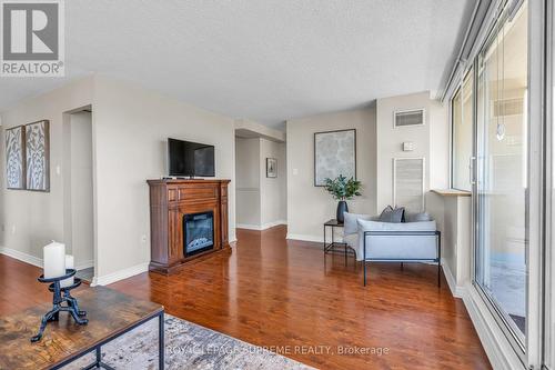 1907 - 3590 Kaneff Crescent, Mississauga, ON - Indoor Photo Showing Living Room With Fireplace