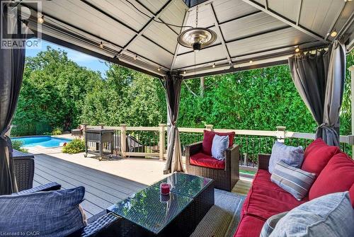 Outdoor covered patio featuring a dark grey composite deck, white gazebo structure, string lighting, and a suspended patio heater - 5140 Crimson King Way, Beamsville, ON - Outdoor With Deck Patio Veranda With Exterior