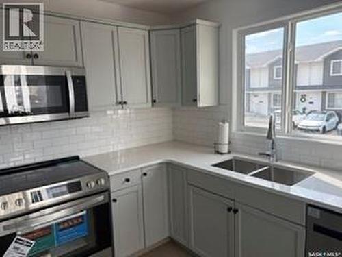 35 4850 Harbour Landing Drive, Regina, SK - Indoor Photo Showing Kitchen With Double Sink