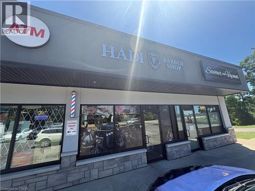 Retail storefront featuring a stone veneer facade and prominent exterior signage - 209 Lexington Road Unit# F, Waterloo, ON 