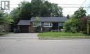 Brick exterior with a dark shingled roof, featuring a single-car garage and a paved driveway - 8 Marlborough Road, Guelph, ON  - Outdoor 