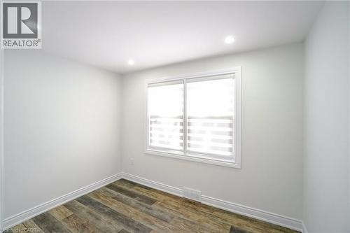 Bright window with zebra blinds, white trim, and wood-finish flooring - 8 Marlborough Road, Guelph, ON - Indoor Photo Showing Other Room