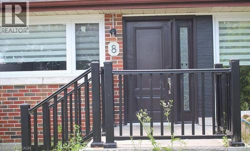 Brick facade with a dark entry door featuring a decorative glass sidelight - 8 Marlborough Road, Guelph, ON - Outdoor