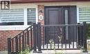 Brick facade with a dark entry door featuring a decorative glass sidelight - 8 Marlborough Road, Guelph, ON  - Outdoor 