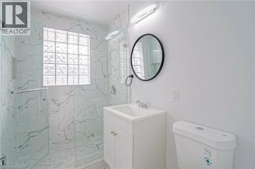 Tiled shower with glass enclosure, integrated niche, and glass block window - 8 Marlborough Road, Guelph, ON - Indoor Photo Showing Bathroom
