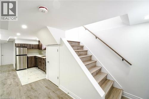 Staircase with wood-finish treads and a dark wood handrail - 8 Marlborough Road, Guelph, ON - Indoor