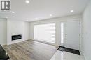 Entryway featuring a white paneled door with decorative sidelight, wood-finish flooring, and recessed ceiling lights - 8 Marlborough Road, Guelph, ON  - Indoor With Fireplace 
