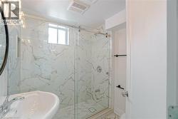 Contemporary bathroom featuring a walk-in shower with a sliding glass door - 
