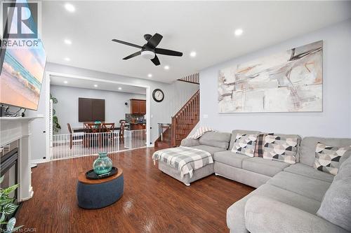 Spacious living area featuring wood-finish flooring, recessed lighting, and a ceiling fan - 79 Garinger Crescent, Hamilton, ON - Indoor Photo Showing Living Room With Fireplace