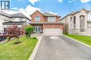 Brick and stone facade residence featuring a double-door entry, an attached two-car garage, an arched window, and a concrete pathway leading to the front entrance - 79 Garinger Crescent, Hamilton, ON  - Outdoor With Facade 