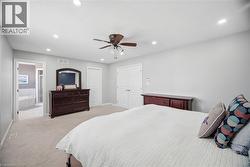 Spacious room featuring neutral carpeting, recessed lighting, and a ceiling fan - 