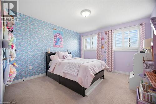 Wall-to-wall carpeting and white baseboards provide a neutral base for the room - 79 Garinger Crescent, Hamilton, ON - Indoor Photo Showing Bedroom