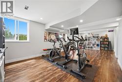 Spacious multi-purpose room featuring wood-finish flooring and recessed lighting - 