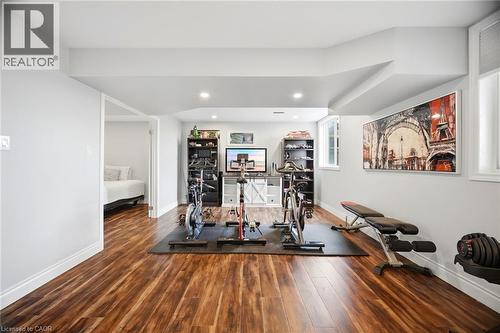 Spacious recreation room featuring wood-finish flooring, recessed lighting, and bright white walls - 79 Garinger Crescent, Hamilton, ON - Indoor Photo Showing Gym Room