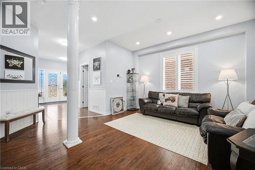 Spacious living area featuring wood-finish flooring, recessed lighting, and a decorative column - 79 Garinger Crescent, Hamilton, ON - Indoor Photo Showing Living Room