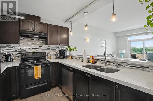 410 - 2 Colonial Drive, Guelph (Pineridge/Westminster Woods), ON - Indoor Photo Showing Kitchen With Double Sink