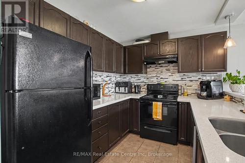 410 - 2 Colonial Drive, Guelph (Pineridge/Westminster Woods), ON - Indoor Photo Showing Kitchen With Double Sink